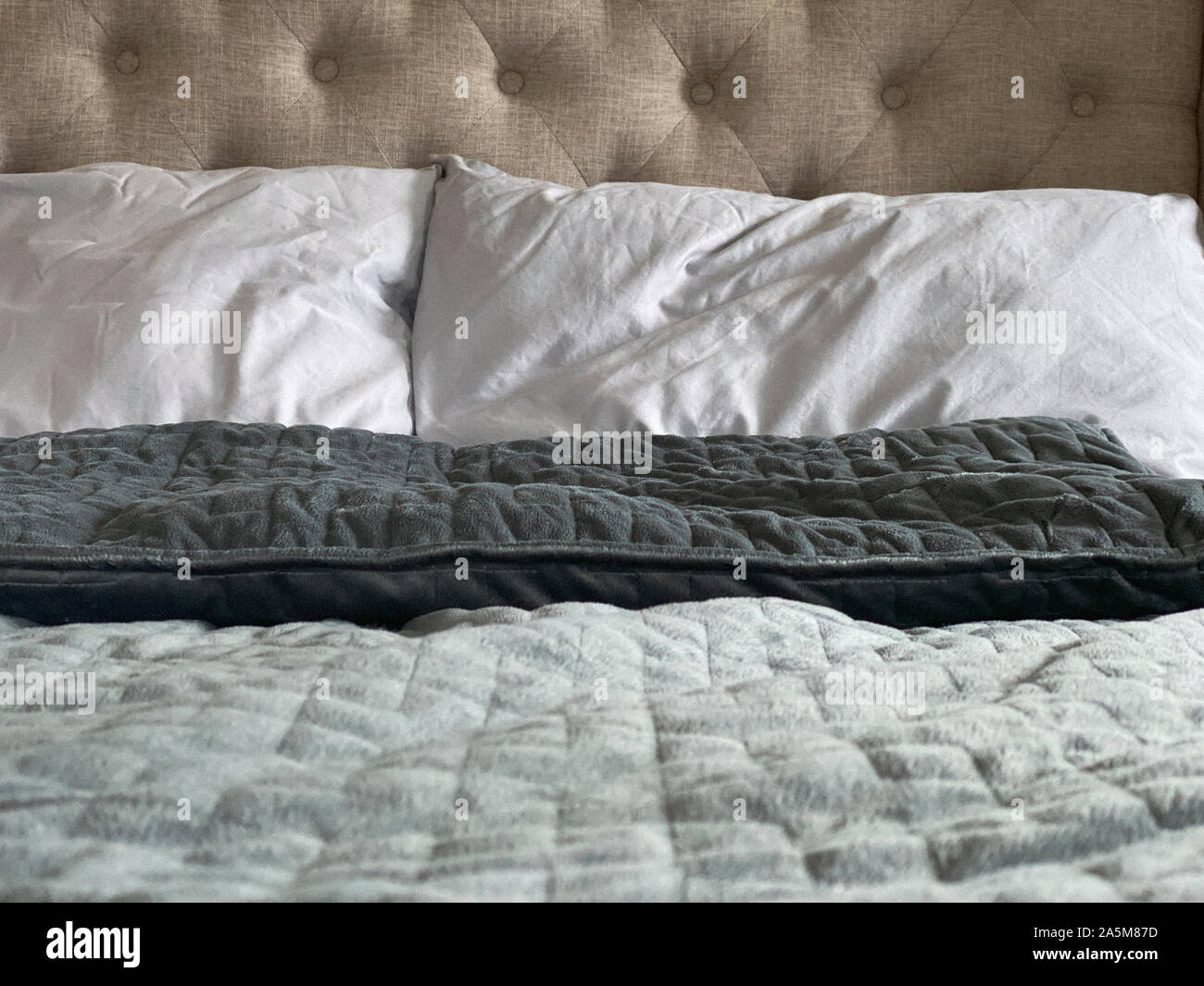 Still life of gray, weighted, blanket in bedroom Stock Photo Alamy