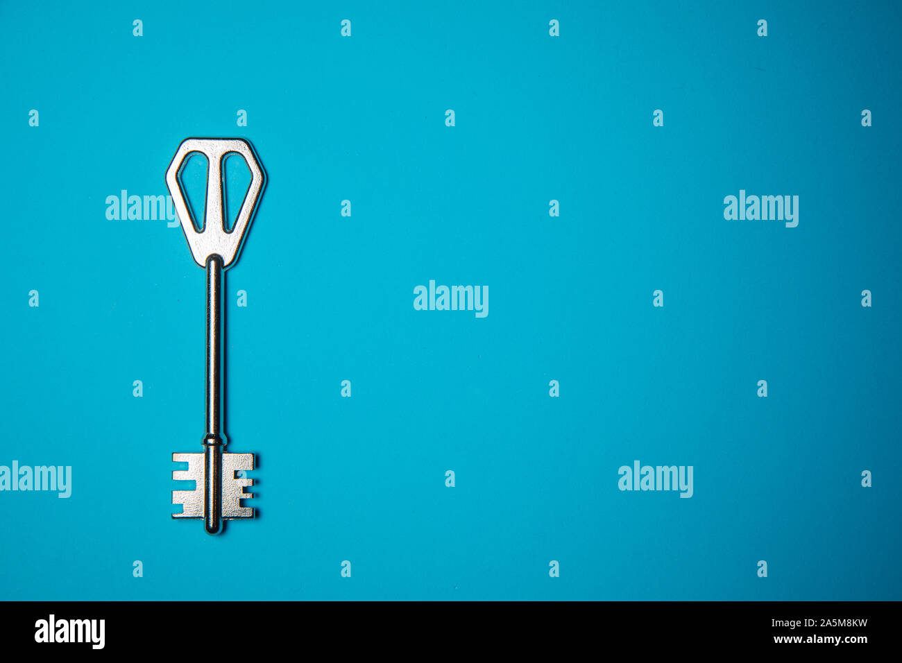 Key on blue background. Minimal creative style Stock Photo