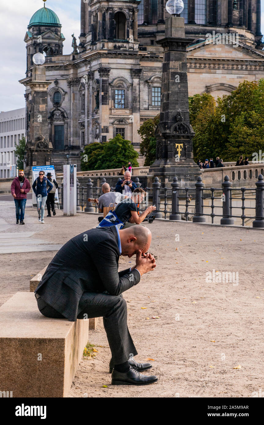 Worried businessman resting head on hands in front of Berlin Cathedral, Berlin, Germany, UK Stock Photo