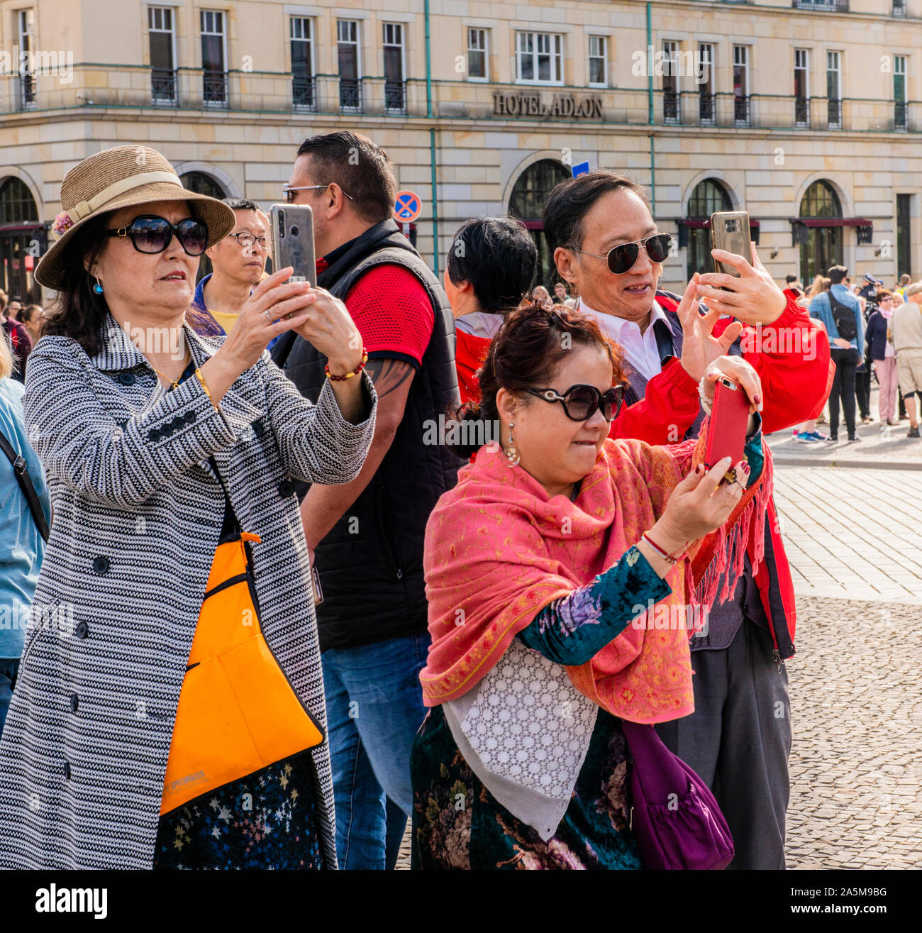 Tourists taking photograph in garden, Bundestag, Berlin, Germany Stock Photo