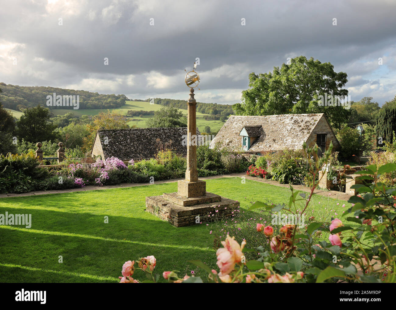 Cotswold Hills landscape with walled garden in the foreground with