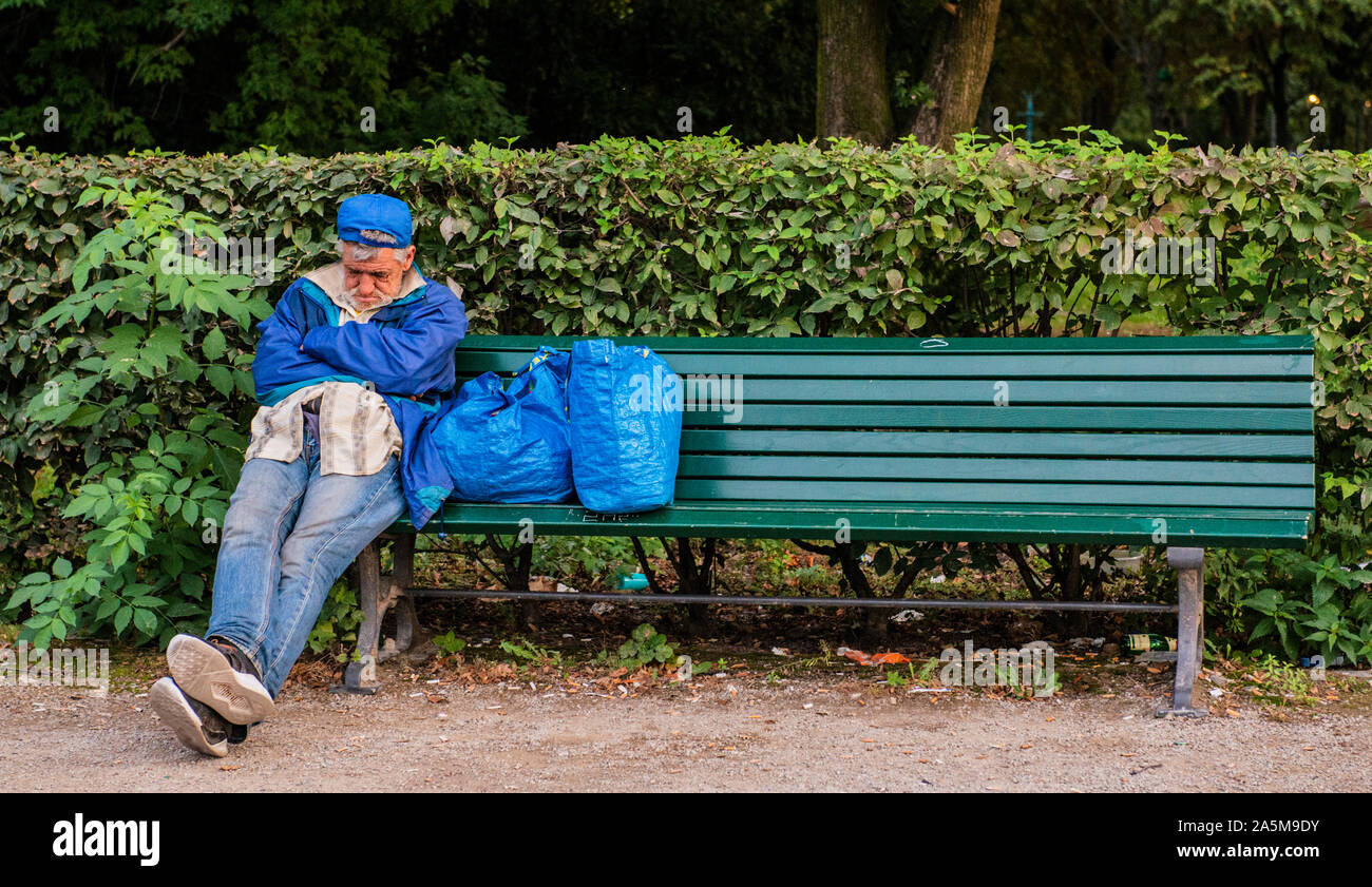 Homeless man sleeping on park bench, Prague, Czech Republic Stock Photo