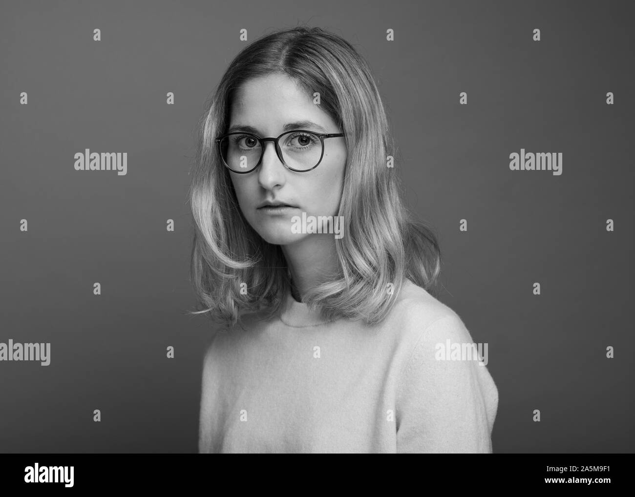 Black and white image of woman wearing glasses Stock Photo