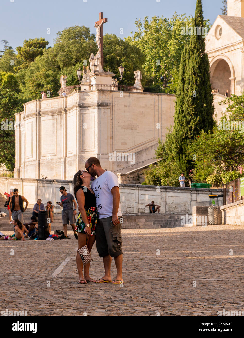 Couple kissing in square, Avignon Notre Dame Cathedral & Square, Avignon, Provence, France Stock Photo