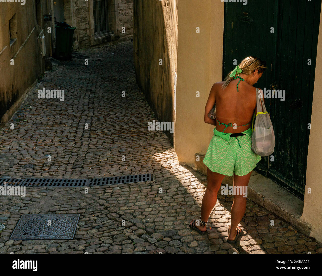 Woman exploring back lane of town, Avignon, Provence, France Stock Photo