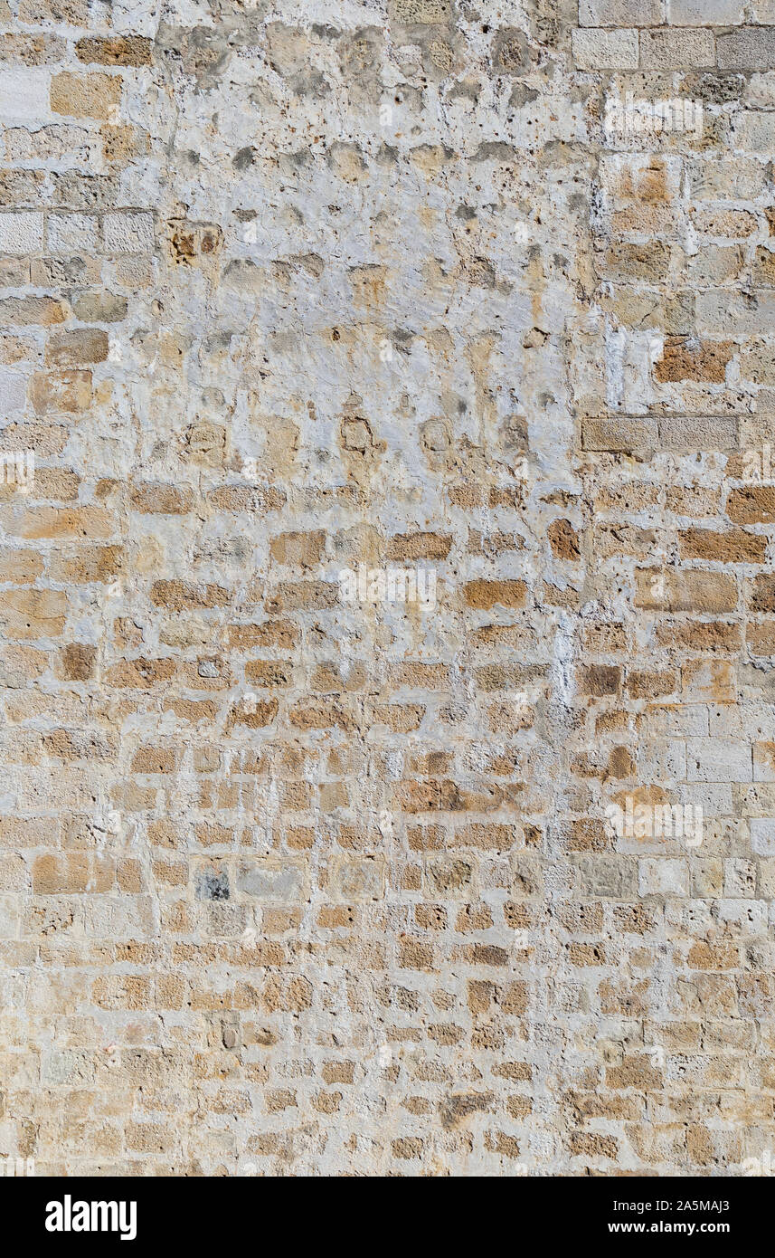 Old and aged brick wall with some weathered plastering. High resolution full frame textured background. Stock Photo