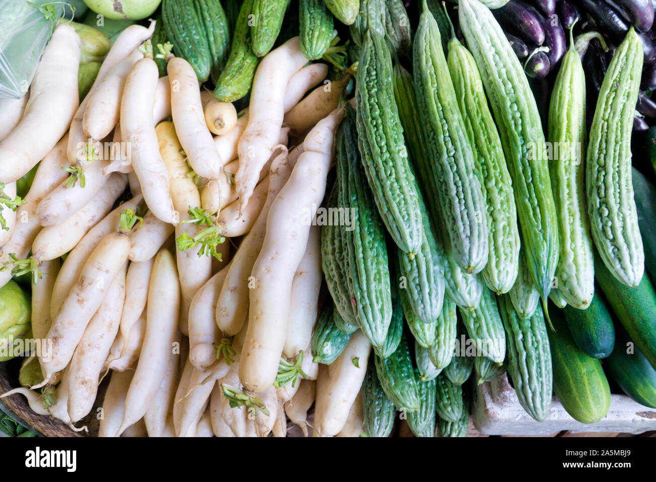 Various vegetables on the counter. organic fresh fruits and vegetables on grocery counter. Selling vegetables in Asia. Stock Photo