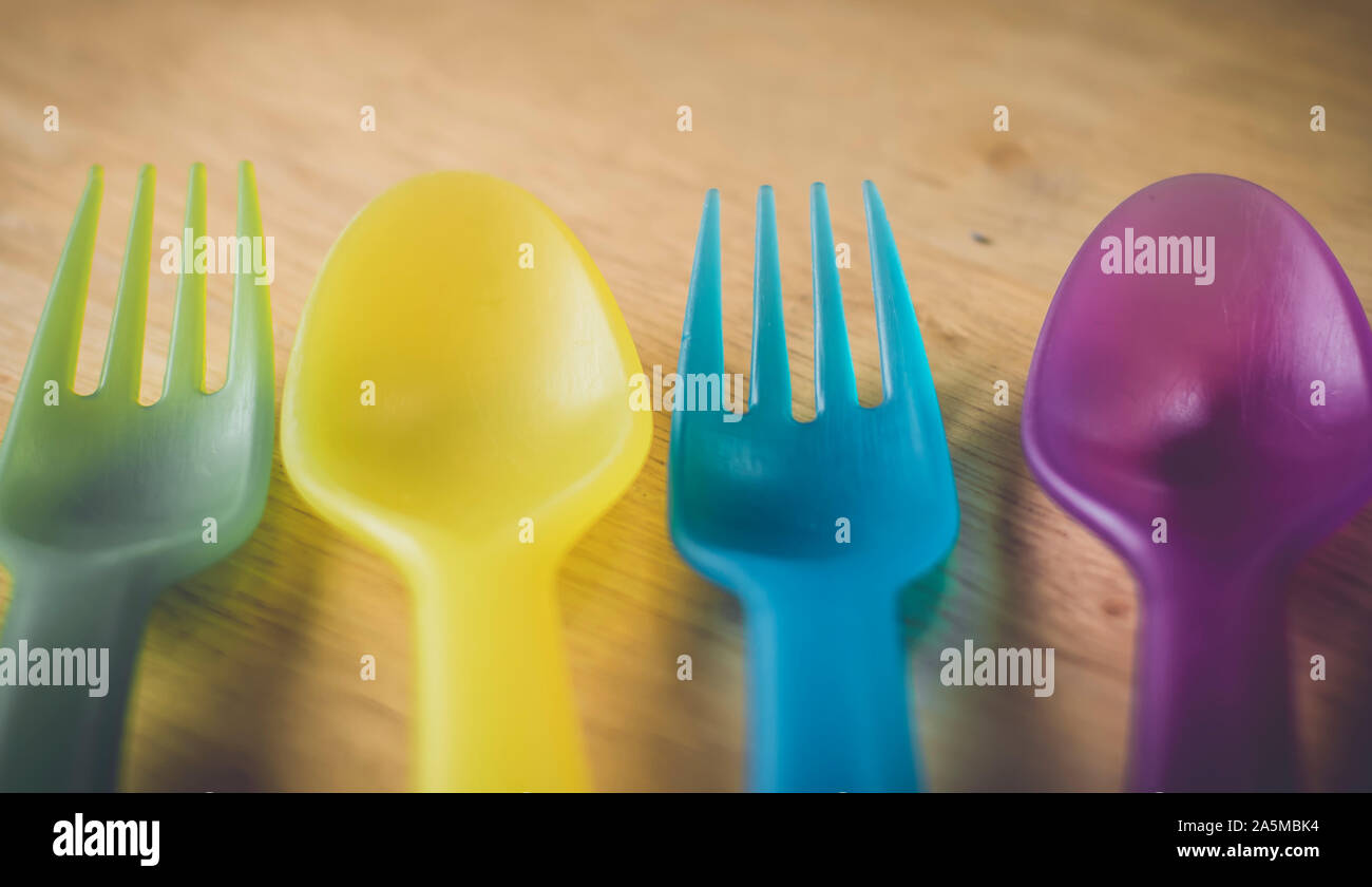 Multicolored plastic forks and spoons.environment concept idea . save