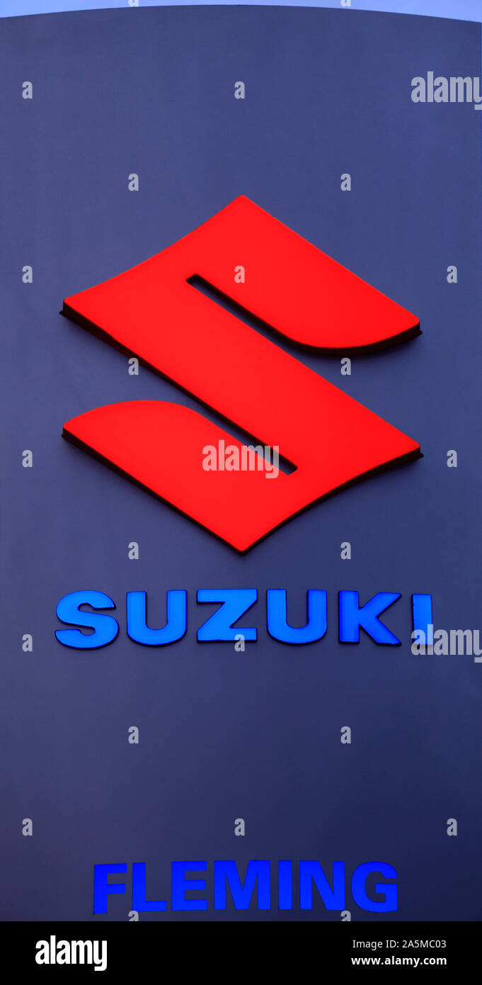 Suzuki, logo, sign, motor cars, industry, illuminated, Fleming Bros, Hunstanton, Norfolk, England Stock Photo