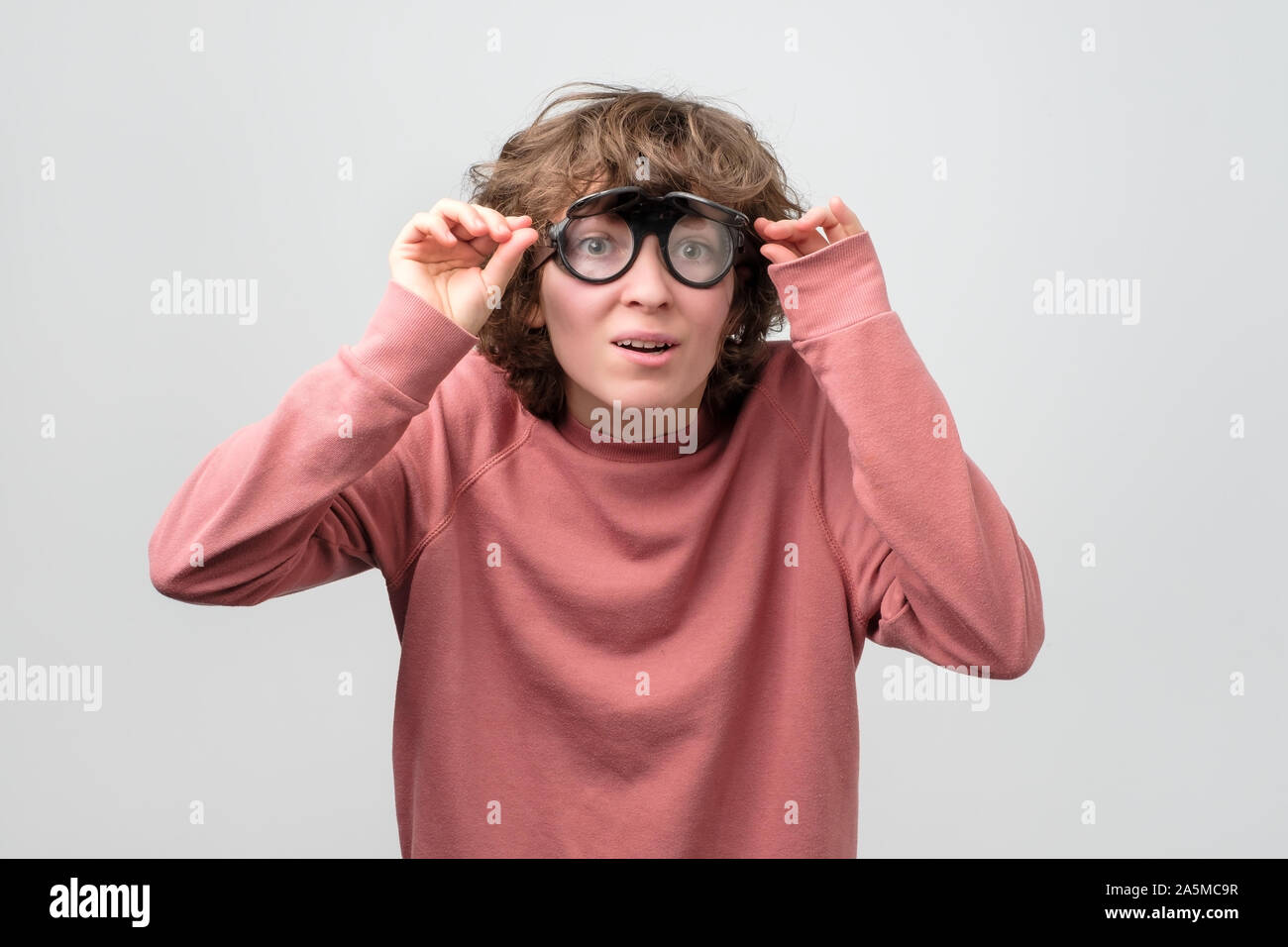 woman in funny glasses looking at camera. I need new lens. Stock Photo