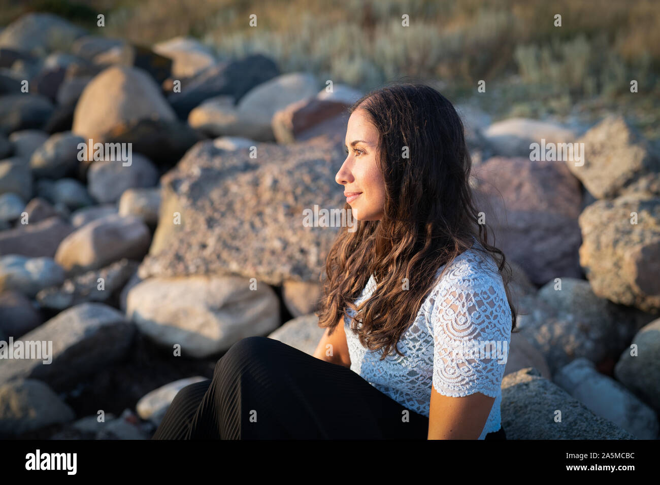 Young woman watching sunset hi-res stock photography and images - Alamy