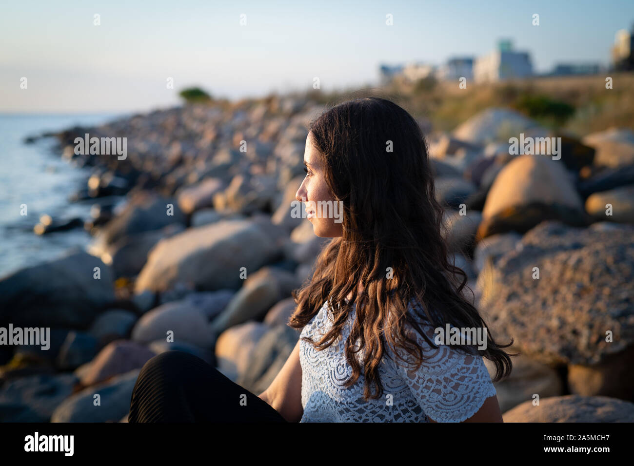 Woman watching sunset over ocean hi-res stock photography and images ...