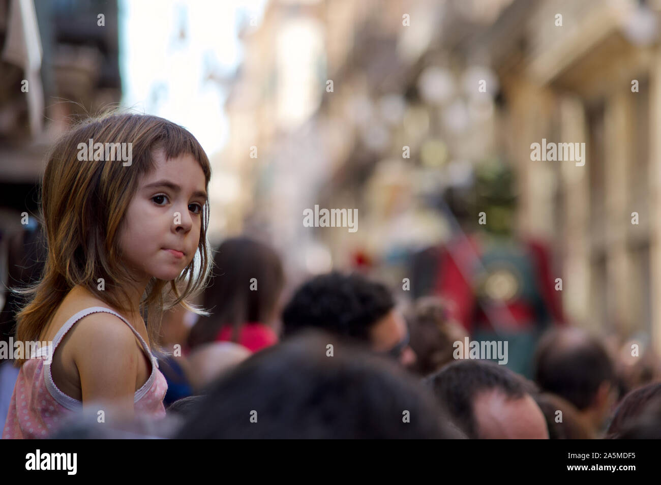 A girl watching the Giants Parade during La Merce Festival 2019 at Placa de Sant Jaume in Barcelona, Spain Stock Photo