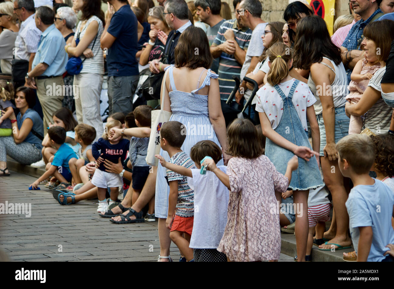 Kids watching the Giants Parade during La Merce Festival 2019 at Placa de Sant Jaume in Barcelona, Spain Stock Photo