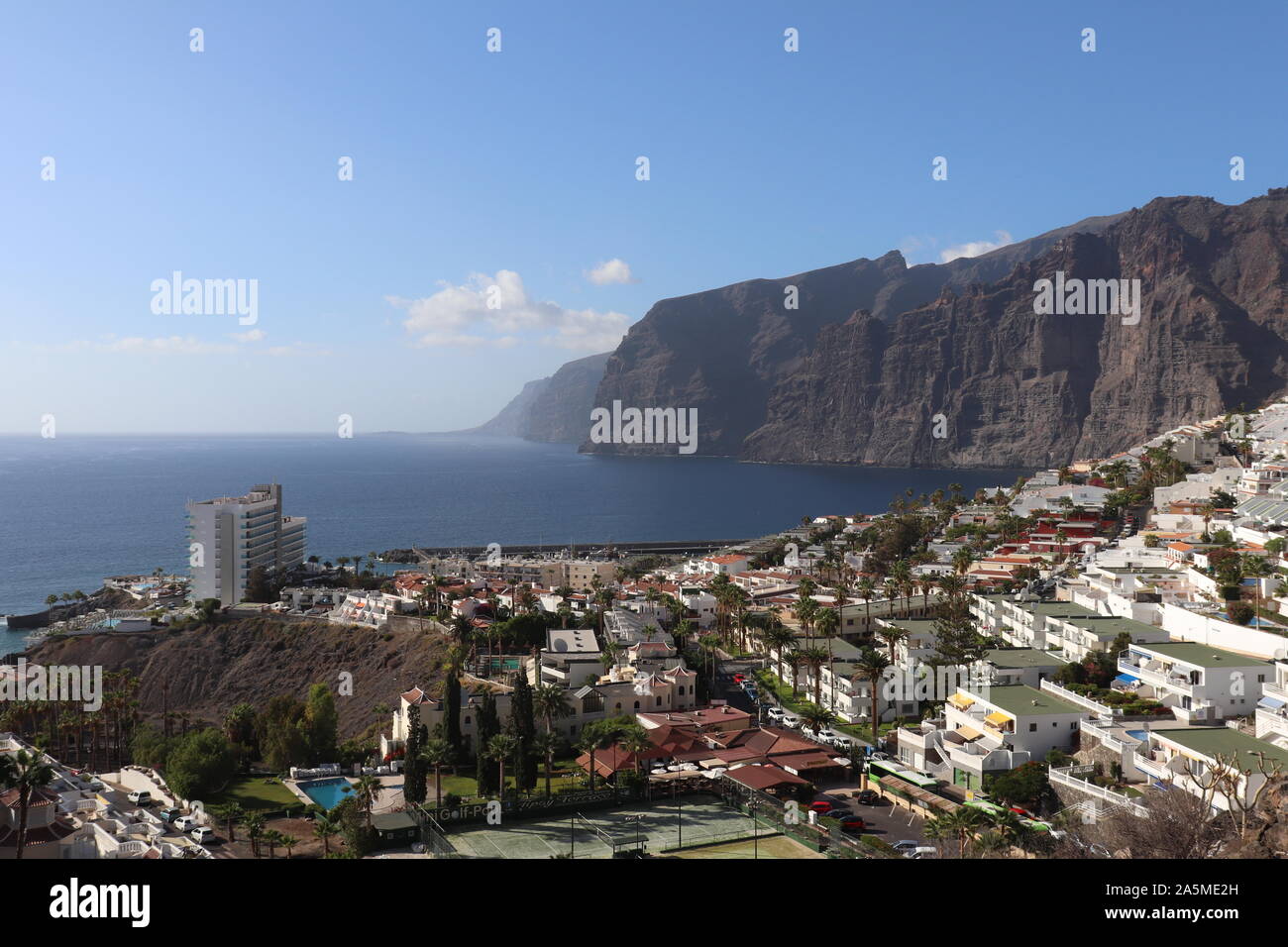 Cliffs towering over the town of Los Gigantes Stock Photo