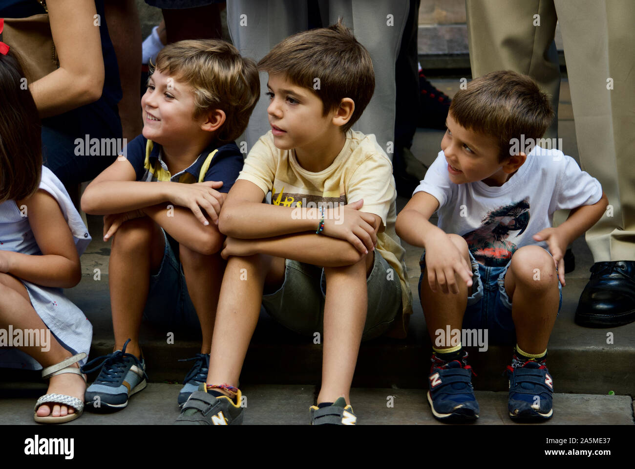 Kids watching the Giants Parade during La Merce Festival 2019 at Placa de Sant Jaume in Barcelona, Spain Stock Photo