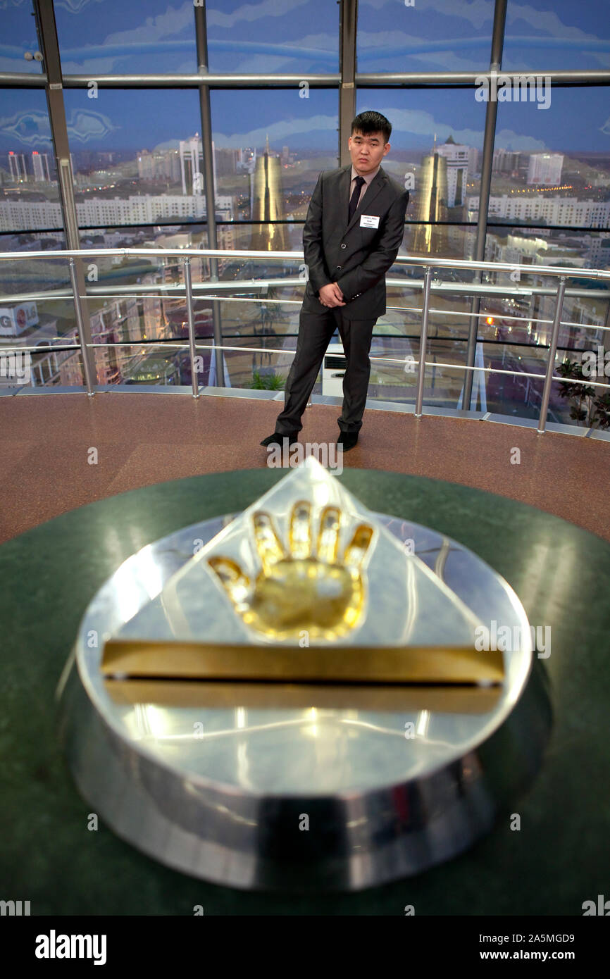 NUR-SULTAN - Guard inside the Bayterek tower near a slab of gold that contains president Nursultan Nazarbayev handprint Stock Photo
