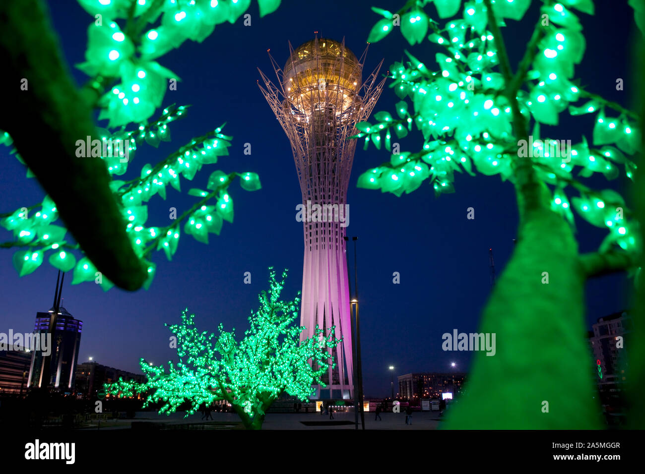NUR-SULTAN - the Bayterek tower on Nurzhol boulevard seen through a fake tree at night. Stock Photo