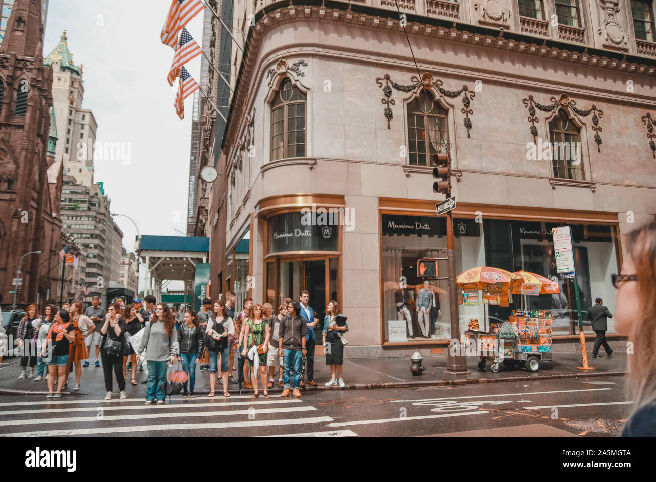 New York, USA - June 17, 2017: People passing on the main street crossroad  of NYC with building and flags background. Corner of Massimo Dutti shop  Stock Photo - Alamy
