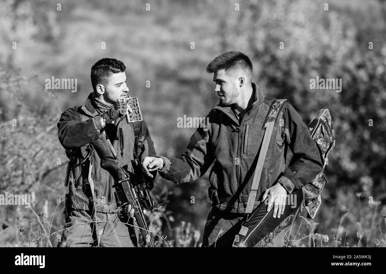 Army forces. Camouflage. Military uniform. Friendship of men hunters. Hunting skills weapon equipment. How turn hunting into hobby. Man hunters with rifle gun. Hunter friend enjoy leisure in field. Stock Photo