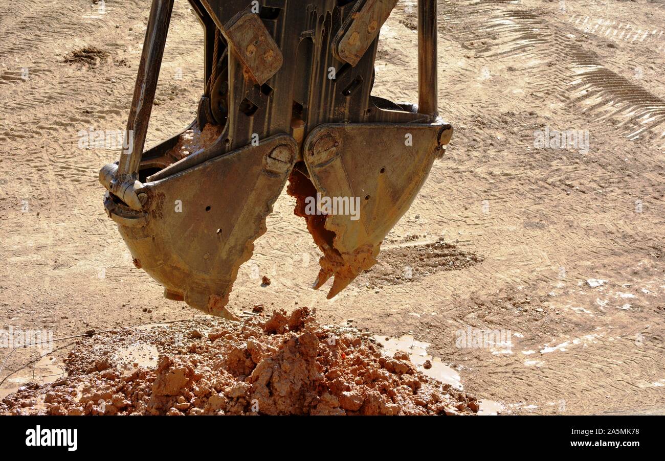 one crane bucket picking up mud Stock Photo