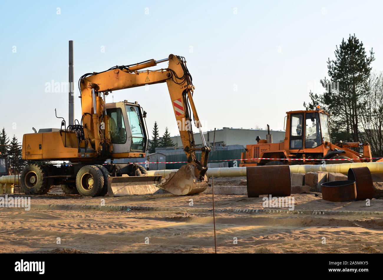 Heavy construction equipment and earthmoving excavators working on a ...