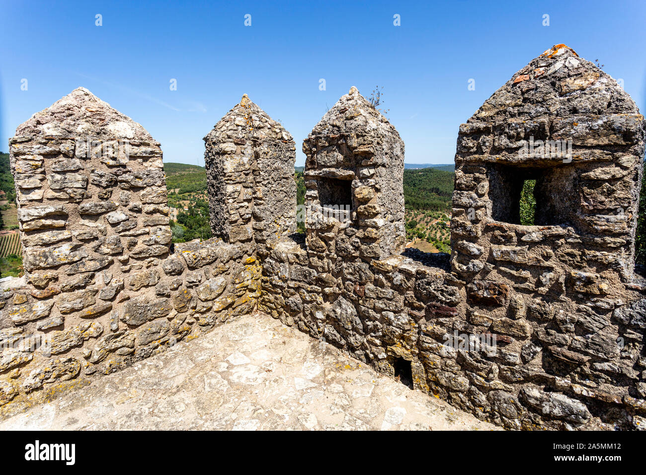Detail of the merlons, crenels and arrow loops of the castle of Penela, built in the 12th century in Penela, Coimbra, Portugal Stock Photo