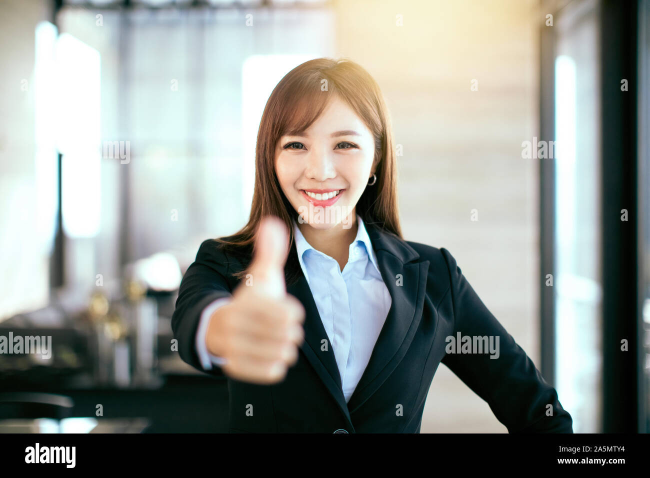 Smiling elegant confident middle aged woman standing in office