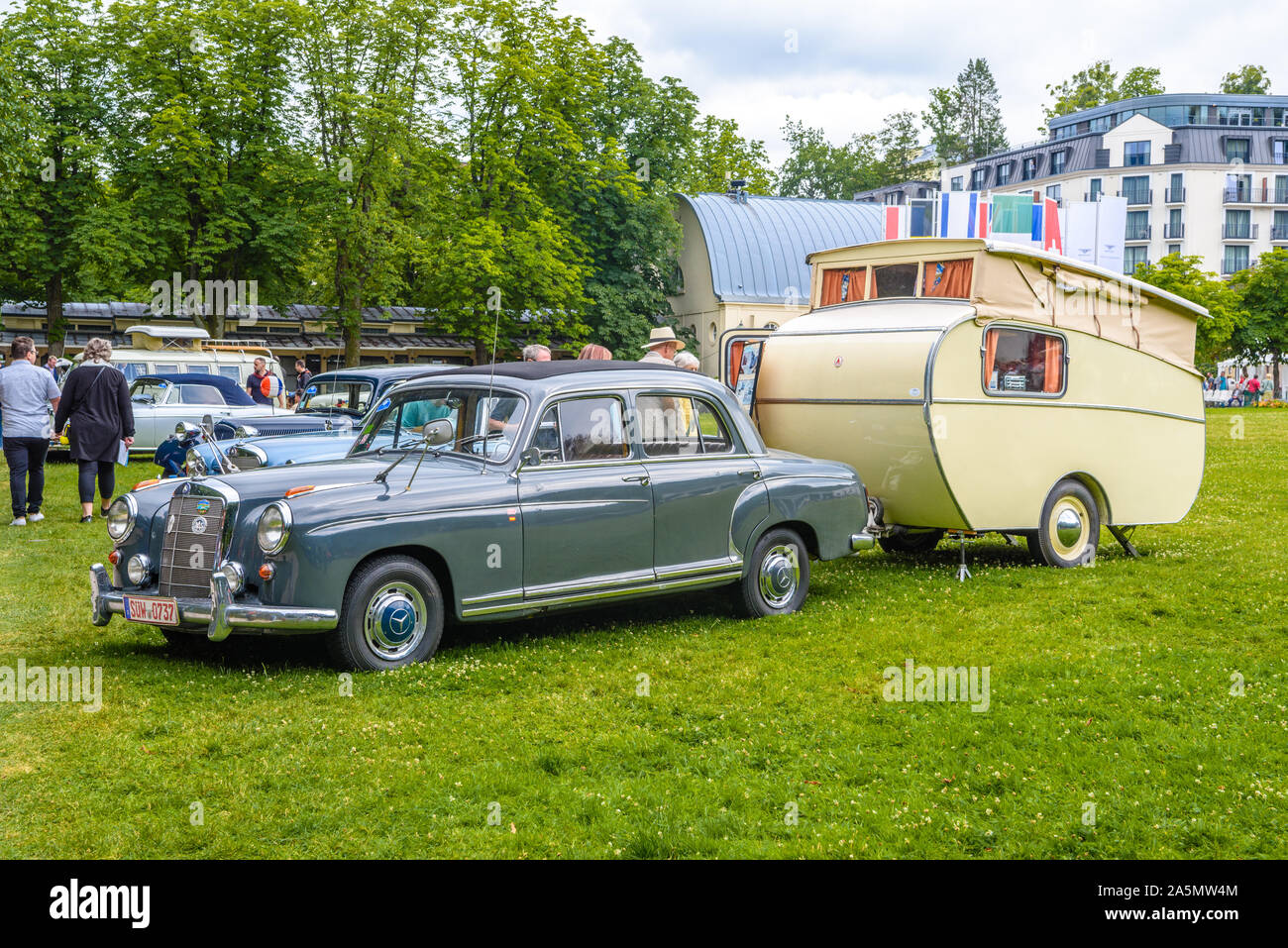 BADEN BADEN, GERMANY - JULY 2019: blue gray MERCEDES-BENZ 220 SE Sedan W128 1958 1960 with trailer house, oldtimer meeting in Kurpark. Stock Photo
