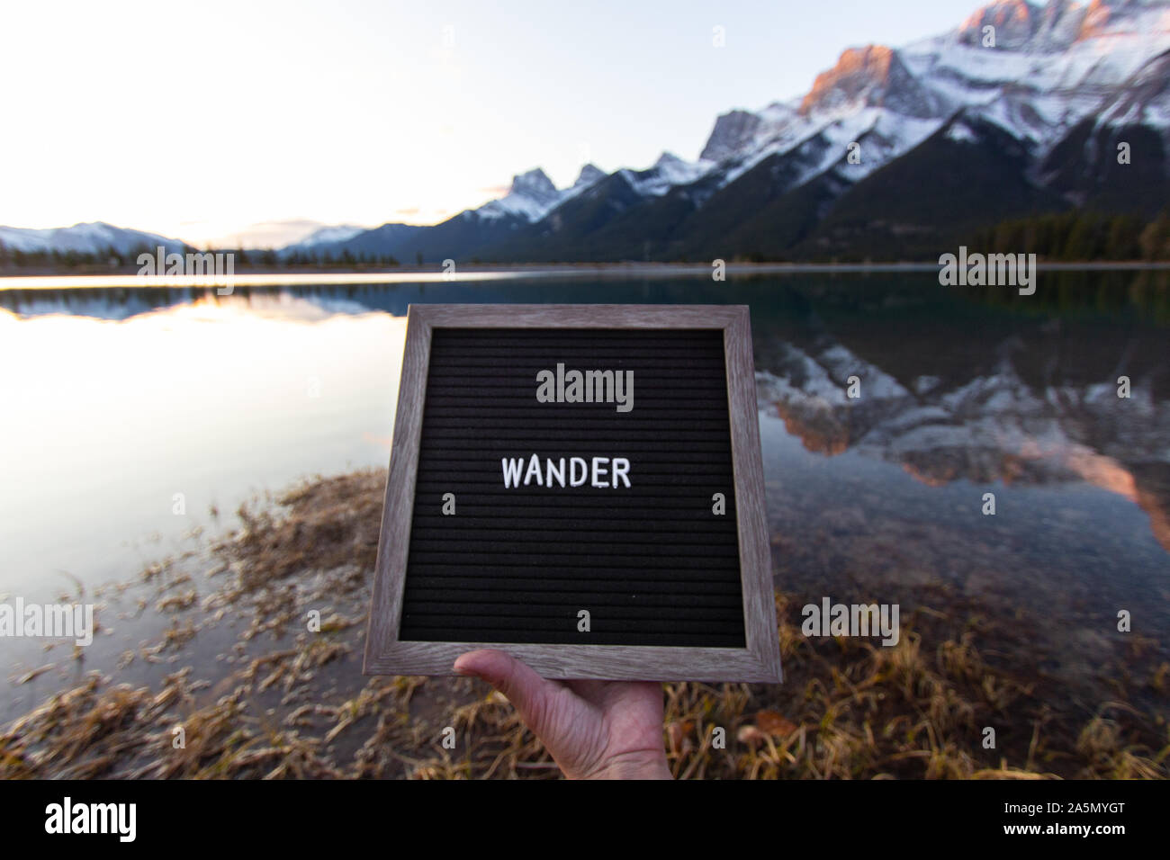 Wander Quote sunrise over mountains in Canmore near Banff National Park Stock Photo