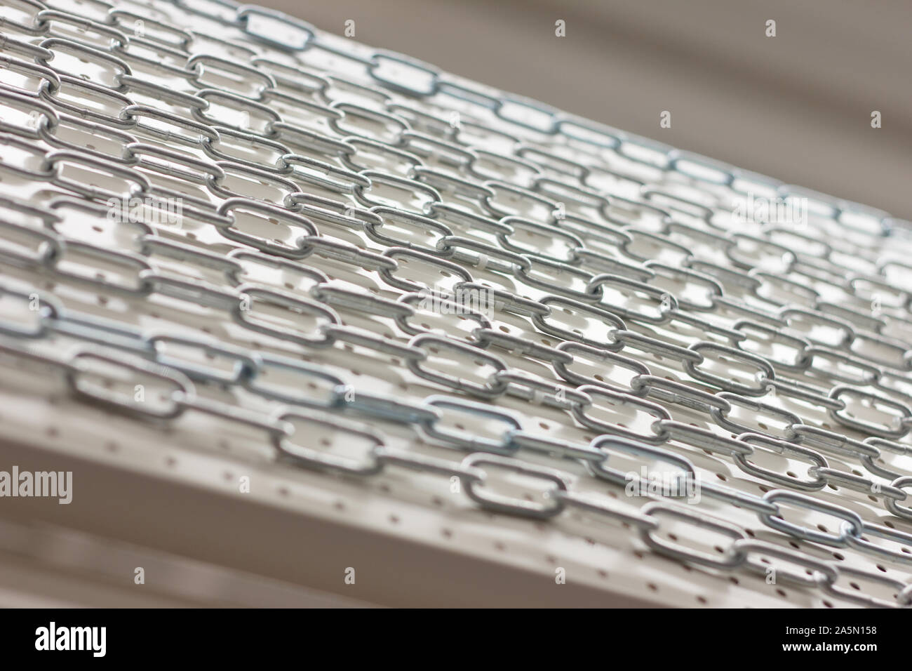 iron chains on a light stand. hardware store Stock Photo Alamy