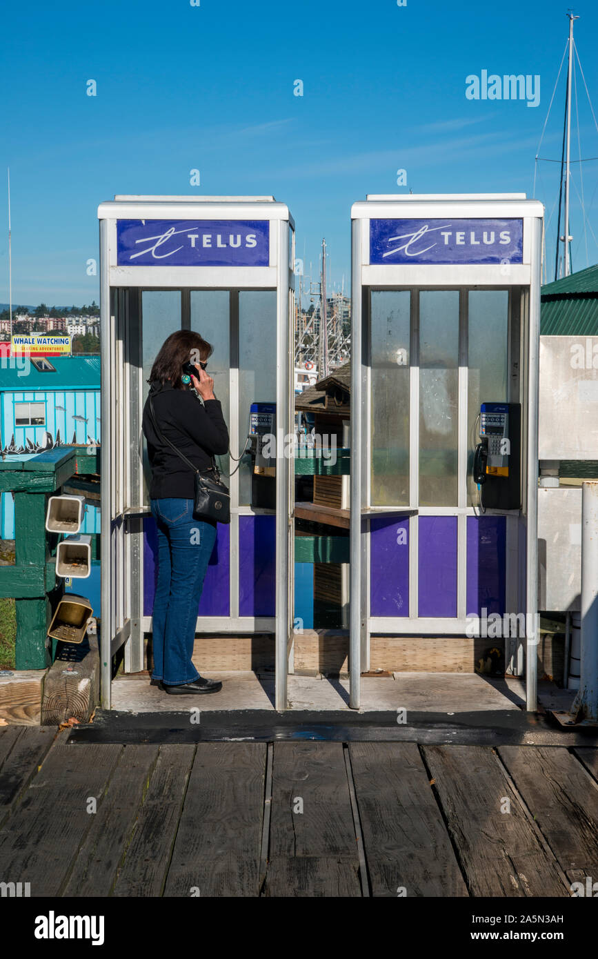 Victoria, British Columbia, Canada. Woman using the telephone in a