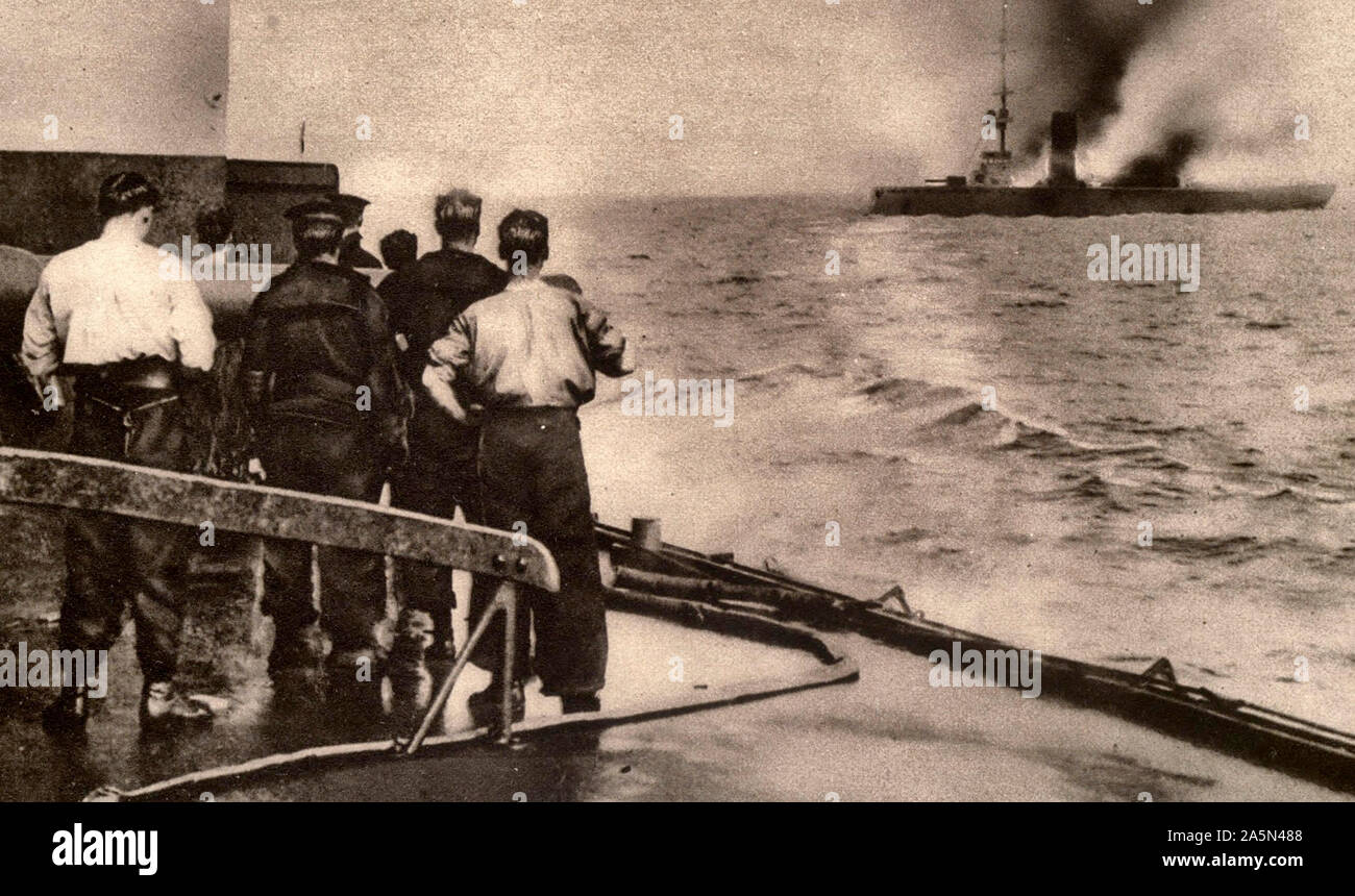 Sinking of the German cruiser Mainz in the Battle of Heligoland. The photograph, taken from the deck of a British warship, shows the cruiser in flames and settling in the water. 1915 Stock Photo