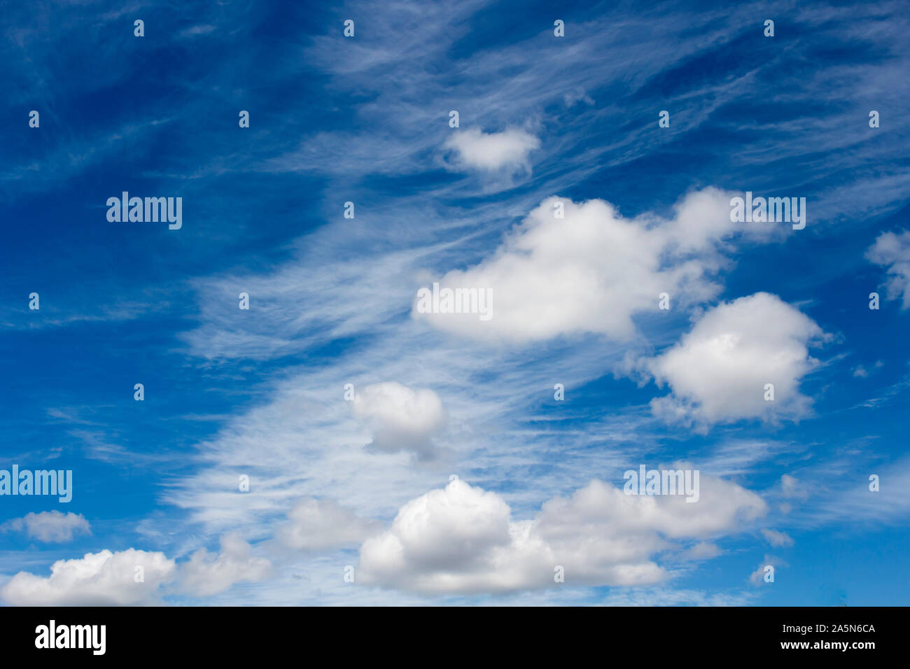 High white wispy cirrus cirro-stratus clouds in a blue Australian sky  sometimes called mare's tails indicate fine weather now but storms coming soon. Stock Photo