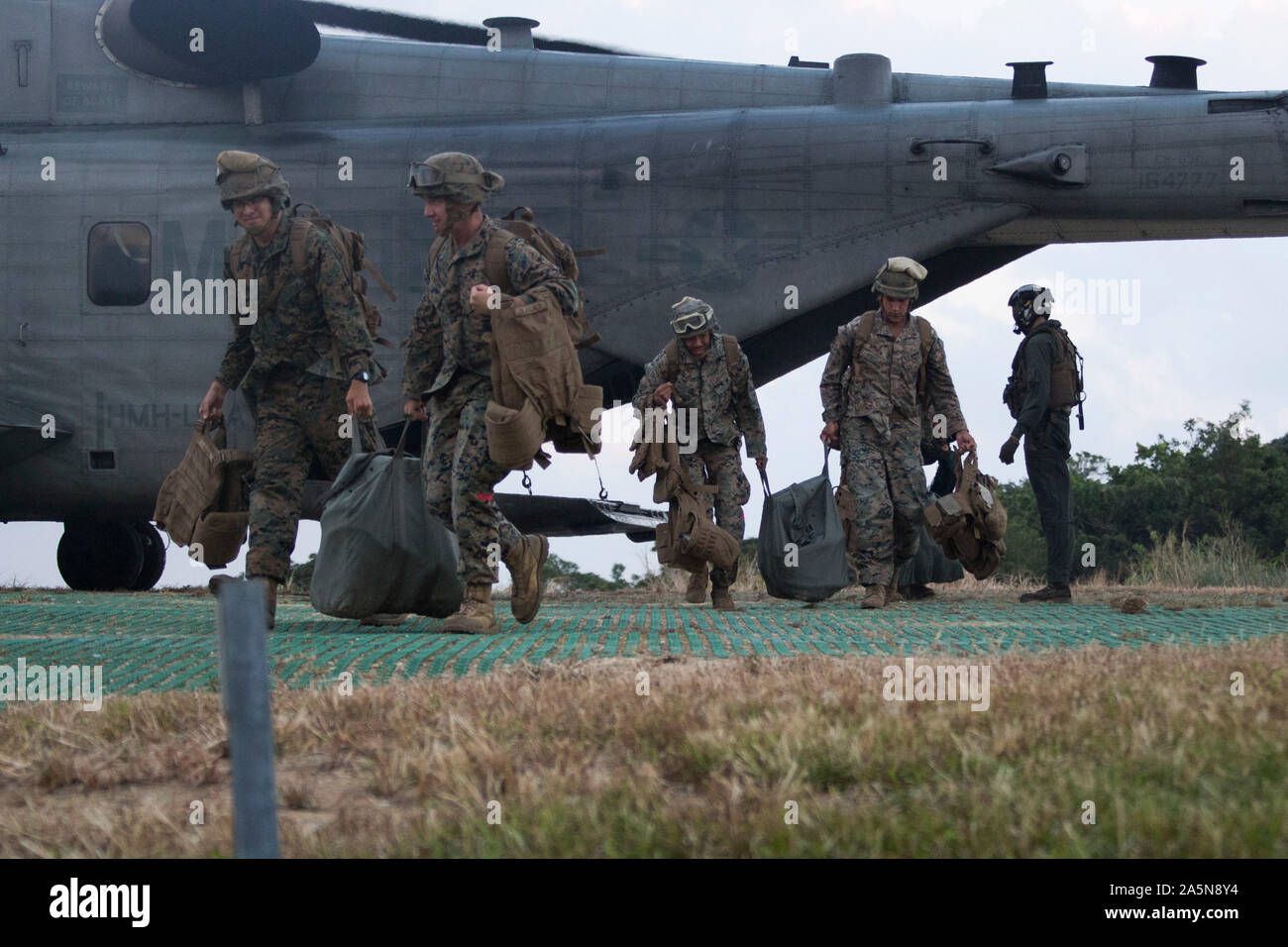 Marines with Combat Logistics Battalion 31, 31st Marine Expeditionary Unit, exit a CH-53E Super Stallion during a helicopter support team training exercise, Northern Training Area, Okinawa, Japan, Oct. 11, 2019. Helicopter Support Teams hook up external loads to helicopters for transportation in areas not suitable for vehicles, making them useful for resupply missions to maneuver forces on the ground. The 31st MEU, the Marine Corps’ only continuously forward-deployed MEU, provides a flexible and lethal force ready to perform a wide range of military operations as the premier crisis response fo Stock Photo