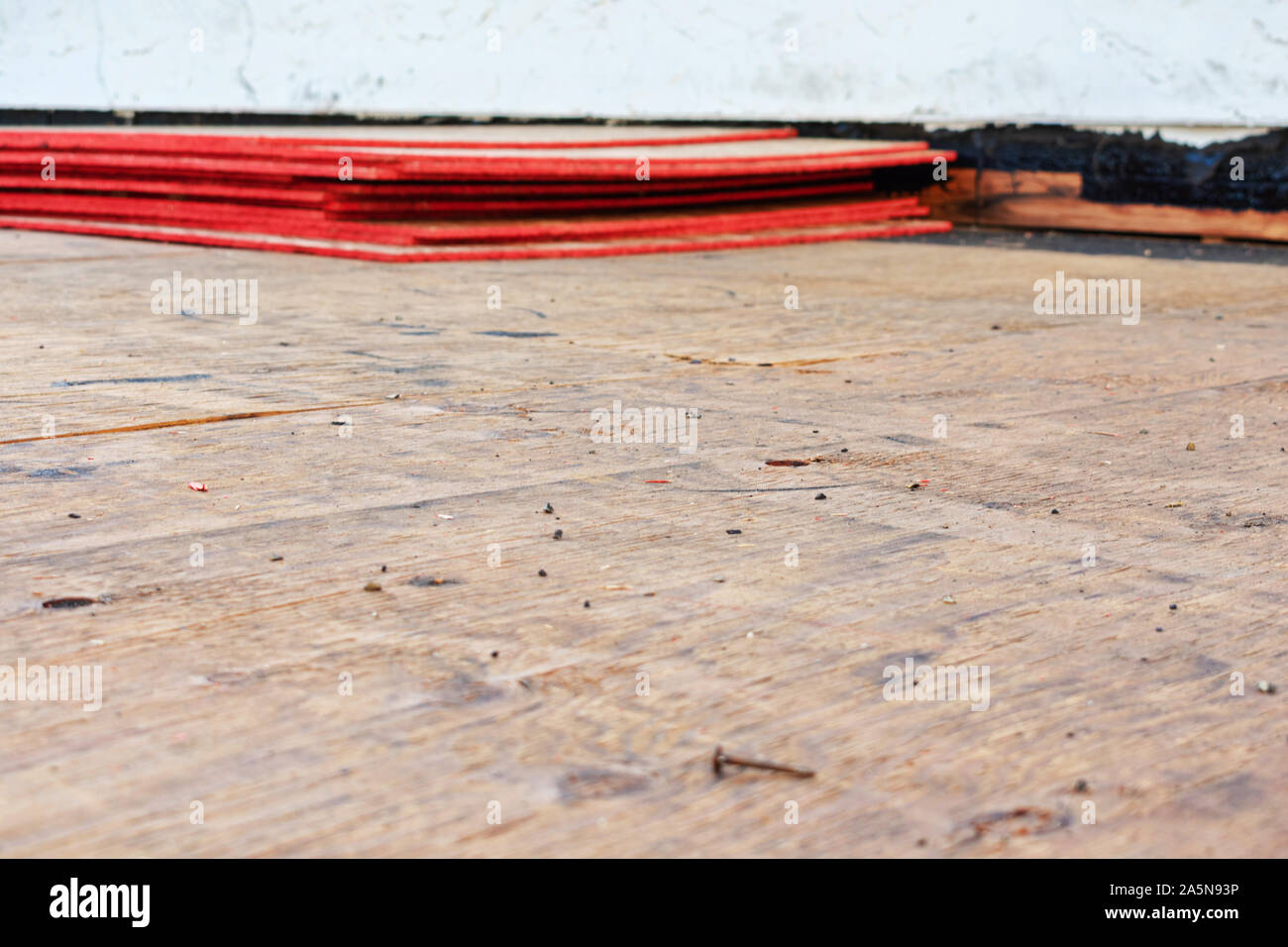 Flat roof repair and replacement in progress. Sheets of stacked plywood on roof sheathing. Stock Photo