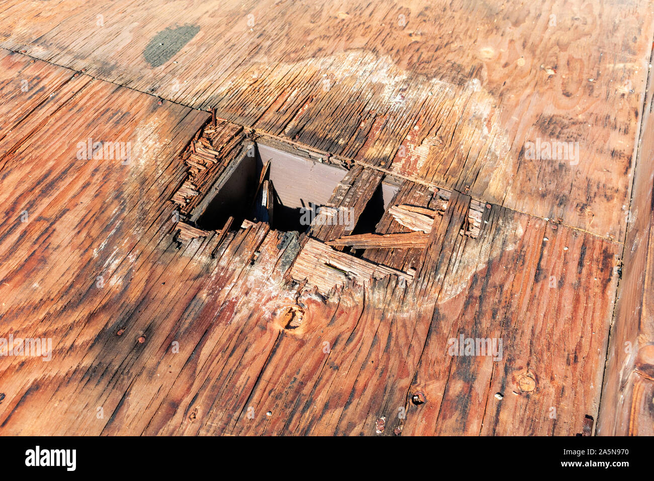 Plywood decking damage and water stains from rain water standing