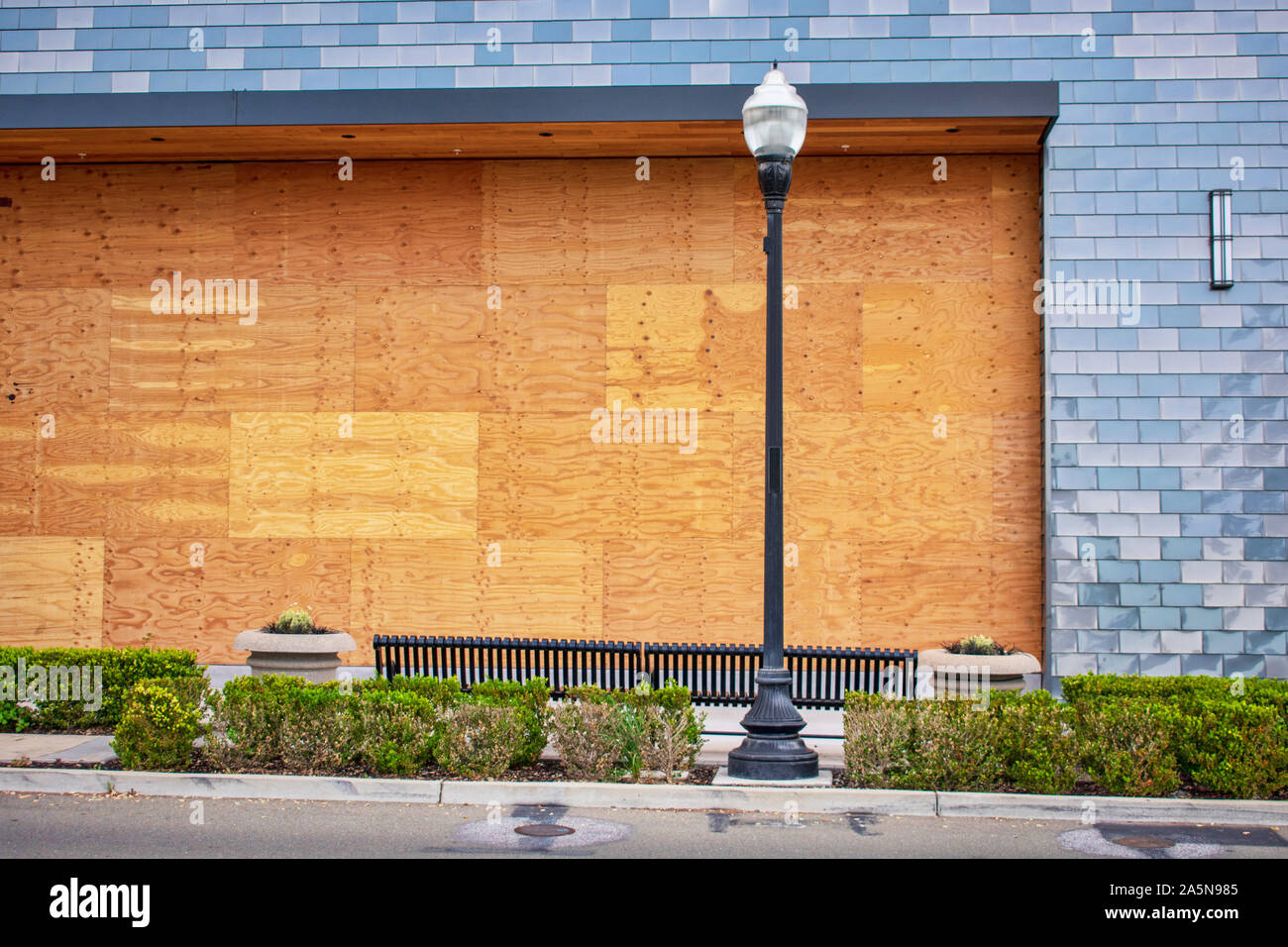 Preparation for hurricane - store, restaurant boarded up with plywood sheets. Plywood shutters prevent unauthorized access to property Stock Photo