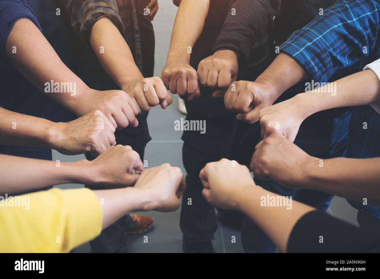 Group of business team work join their hands together with power and ...
