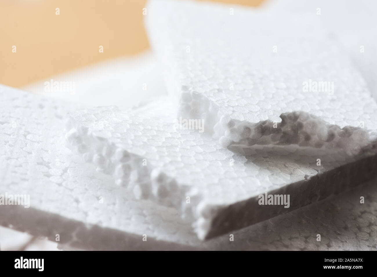 Closeup white polystyrene foam on the cardboard. Polystyrene foam is