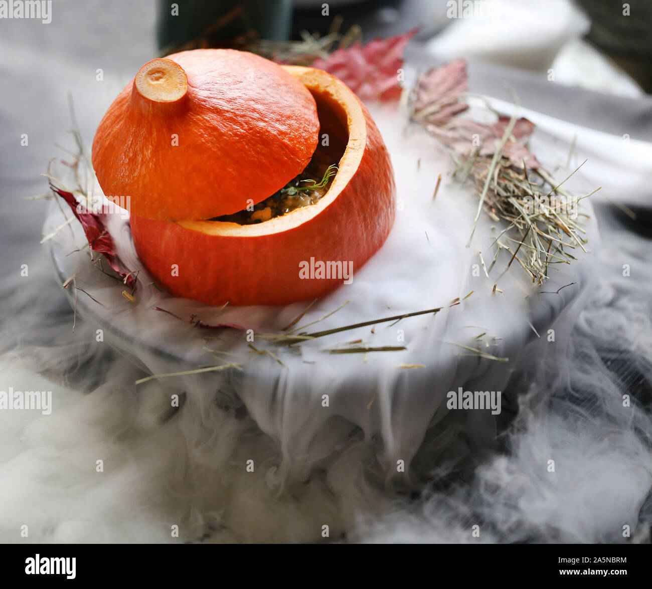 Photo macro of a large red pumpkin on nitrogen in a restaurant Stock Photo