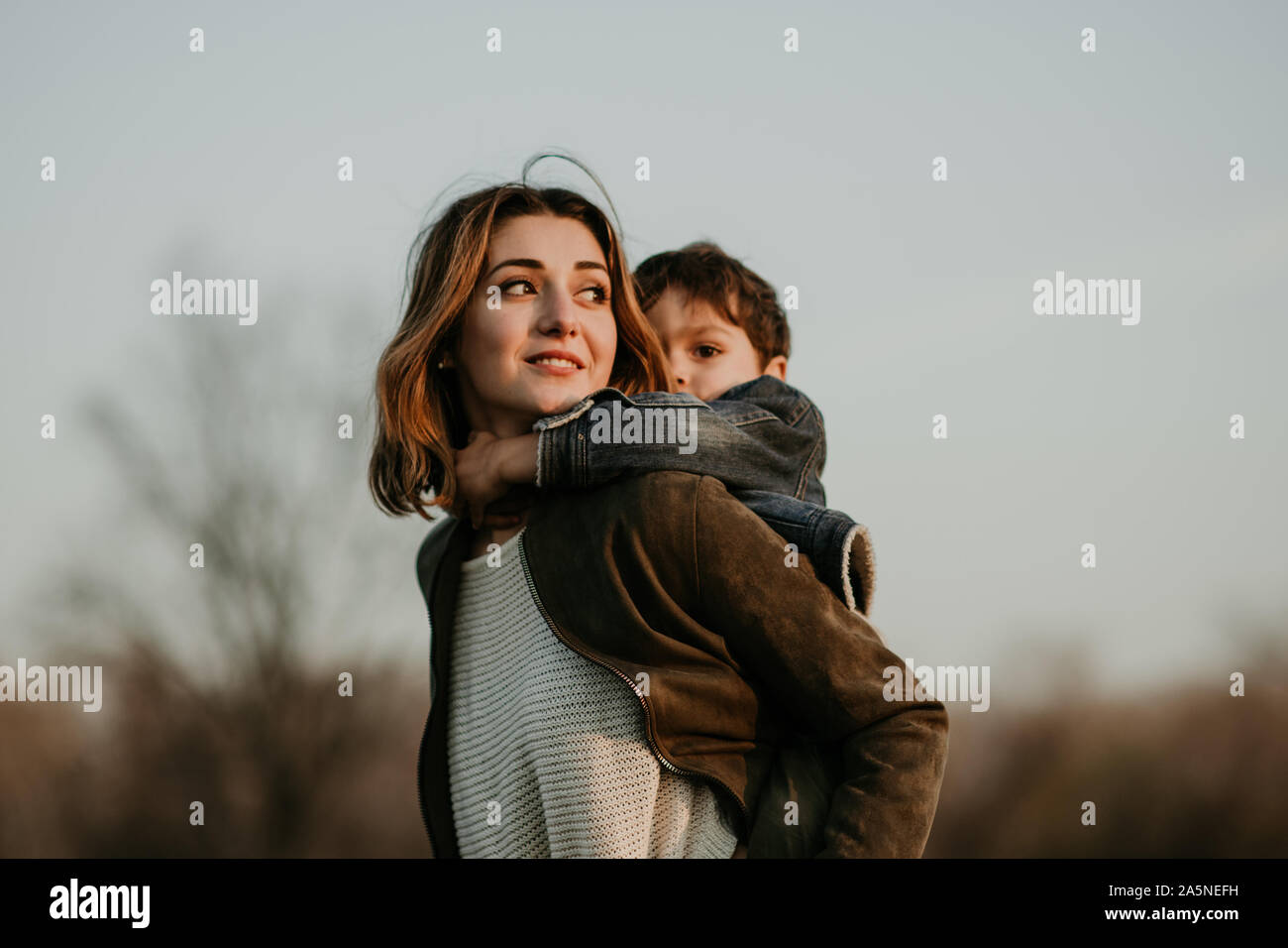 Portrait of happy mother and son spending time together in autumn walk Stock Photo