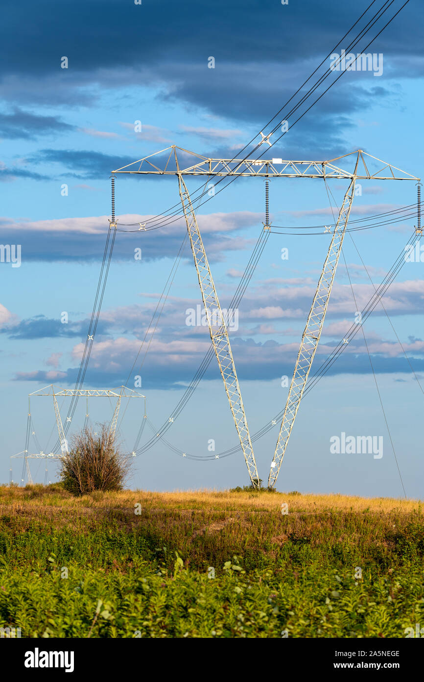 High voltage towers and power lines cross the countryside Stock Photo ...