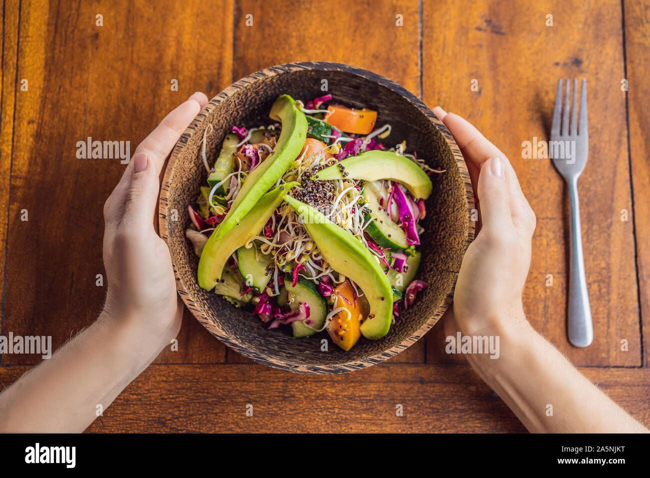 Mixed Green Salad with Grilled Salmon, Quinoa and Avocado on Wood