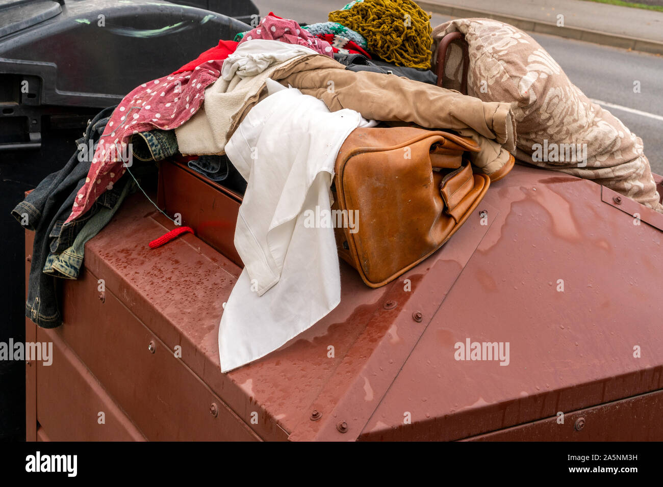 Full container of disposal clothes. Old clothes collection container on