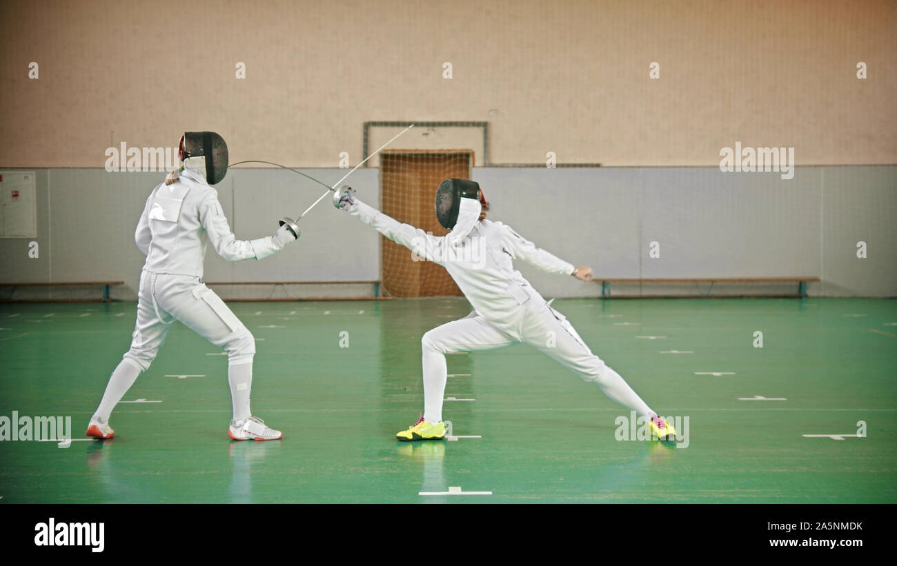 Two fencers are fighting in the school gym indoor Stock Photo Alamy