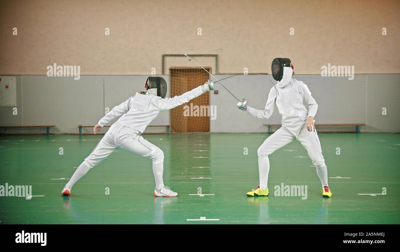Two fencers are fighting in the gym indoor Stock Photo Alamy