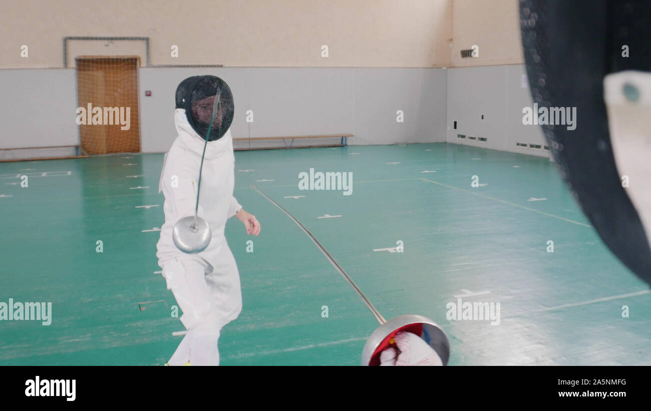 Fencer attacks another fencer in the gym indoor Stock Photo Alamy