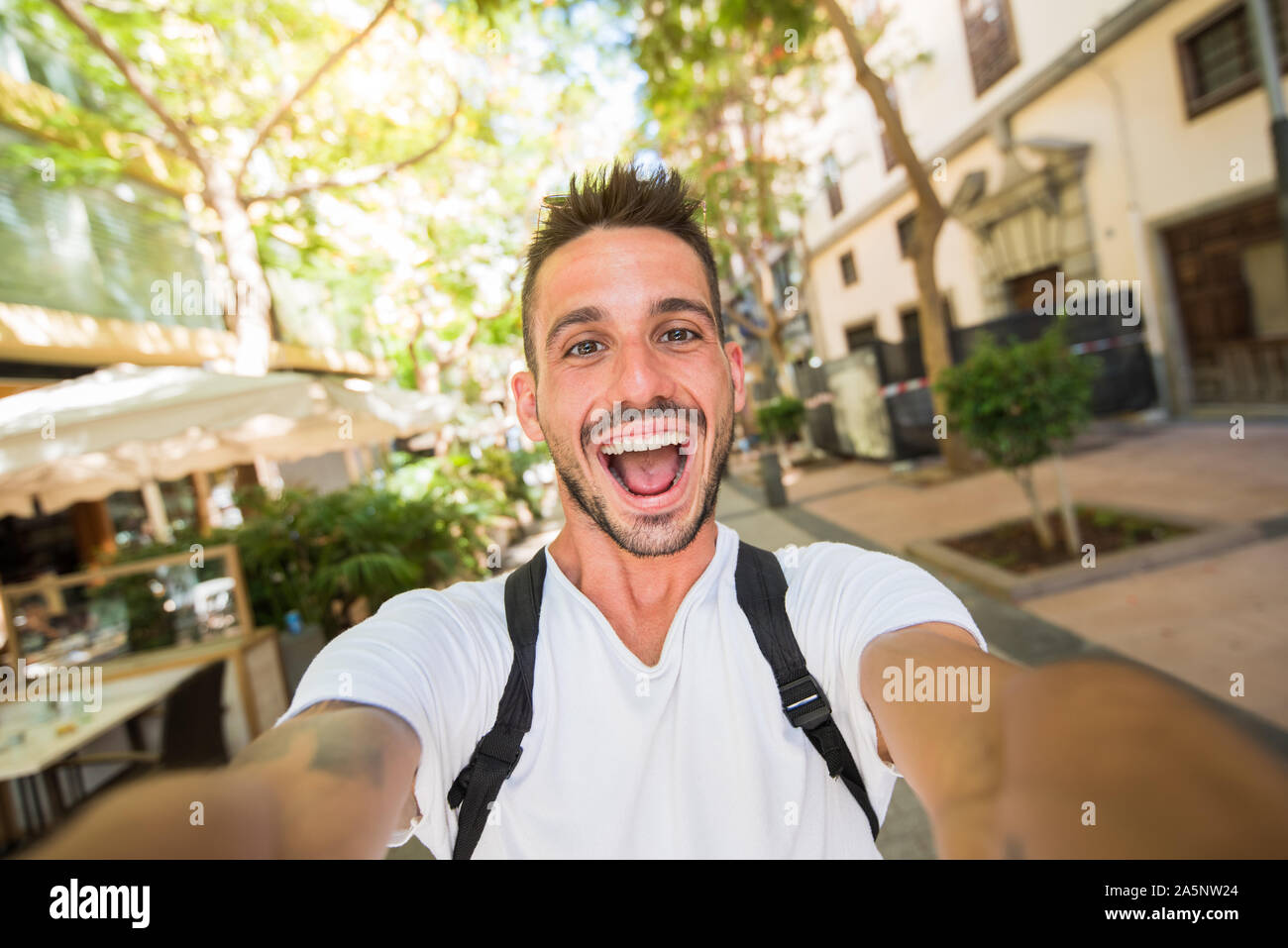 Handsome man takes a selfie walking in the city Stock Photo