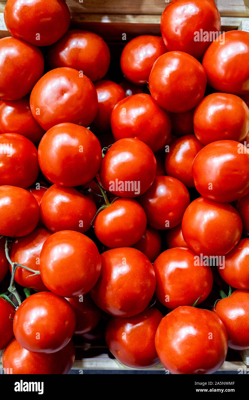 Boxes of bright red tomatoes ready for sale at a farmers market Stock ...